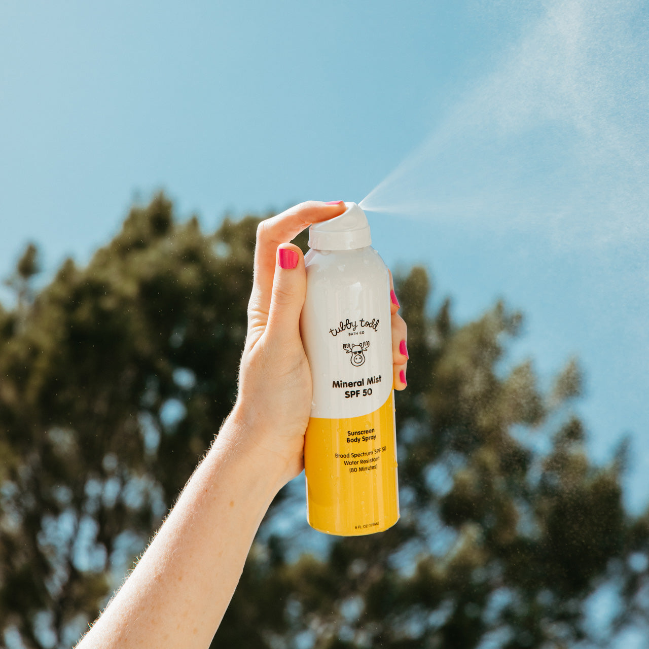 Mama spraying Mineral Mist into sky to show fine mist